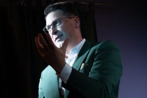 Storyseller in a Green Suit